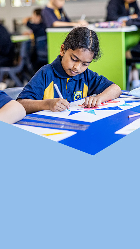 Student writing in the classroom at St Mary's Primary School Rydalmere