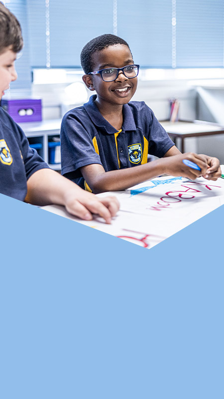 Student smiling in the classroom at St Mary's Primary School Rydalmere