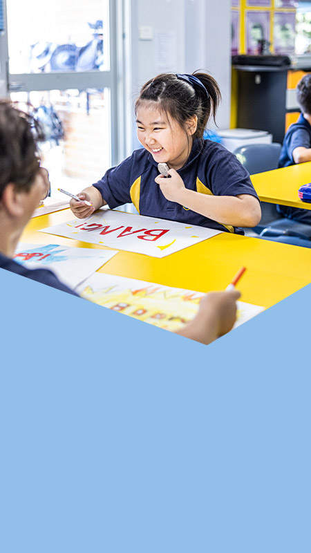 Student painting in the classroom at St Mary's Primary School Rydalmere