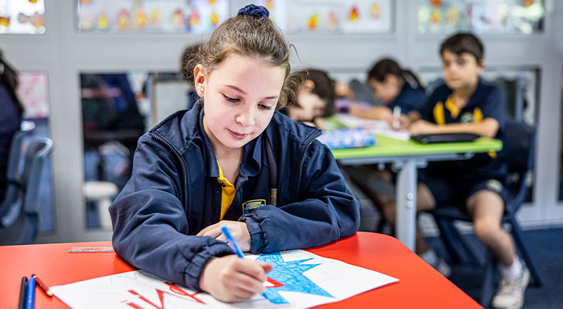 Student drawing in the classroom at St Mary's Primary School Rydalmere