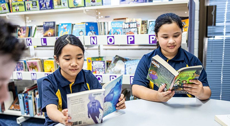 Students reading books in the library at St Mary's Primary School Rydalmere