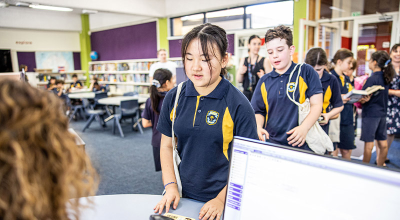 Student borrowing books from the library at St Mary's Primary School Rydalmere