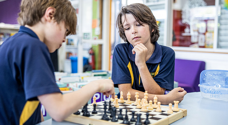 Students playing chess in the library at St Mary's Primary School Rydalmere