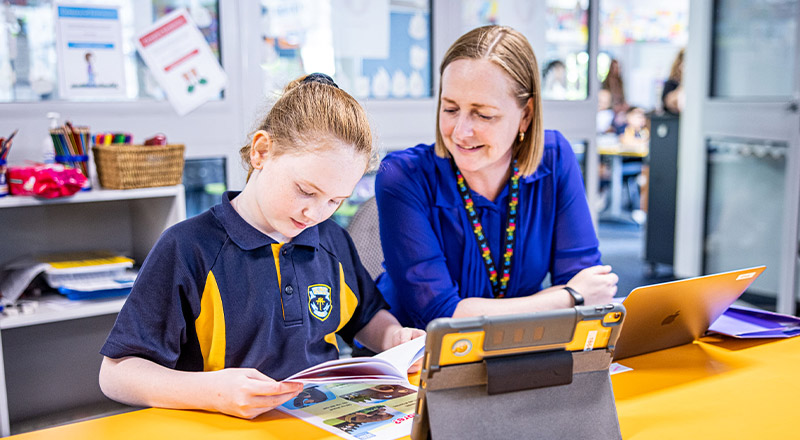 Teachers with her student in the classroom at St Mary's Primary School Rydalmere