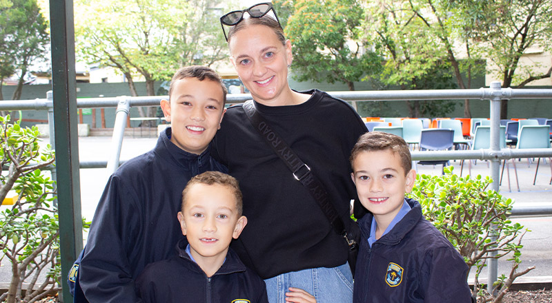 Students with their mother at a school event at St Mary's Primary School Rydalmere