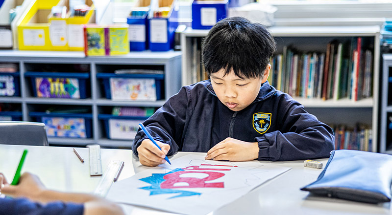 Student drawing in the classroom at St Mary's Primary School Rydalmere