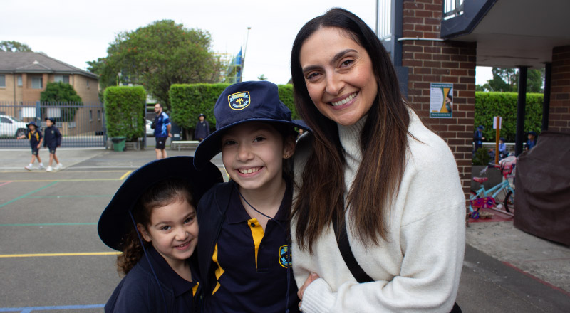 Students with their mother at a school event at St Mary's Primary School Rydalmere