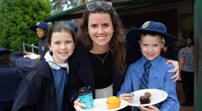 Students with their mother at a school event at St Mary's Primary School Rydalmere