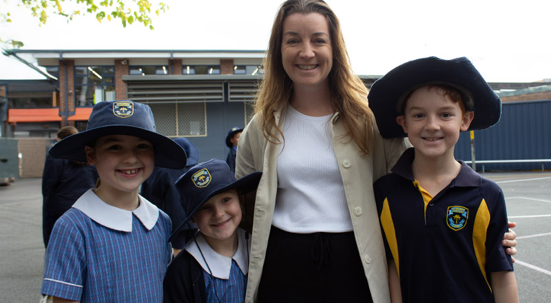 Students with their mother at a school event at St Mary's Primary School Rydalmere