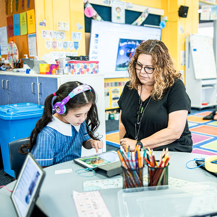 Teacher with her student in the classroom at St Mary's Primary School Rydalmere