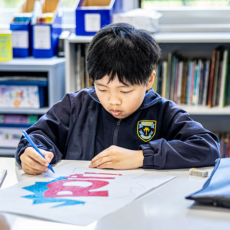 Student drawing in the classroom at St Mary's Primary School Rydalmere