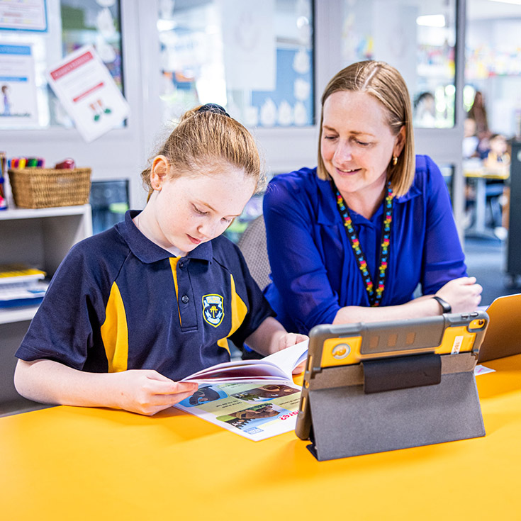 Teacher with her student in the classroom at St Mary's Primary School Rydalmere