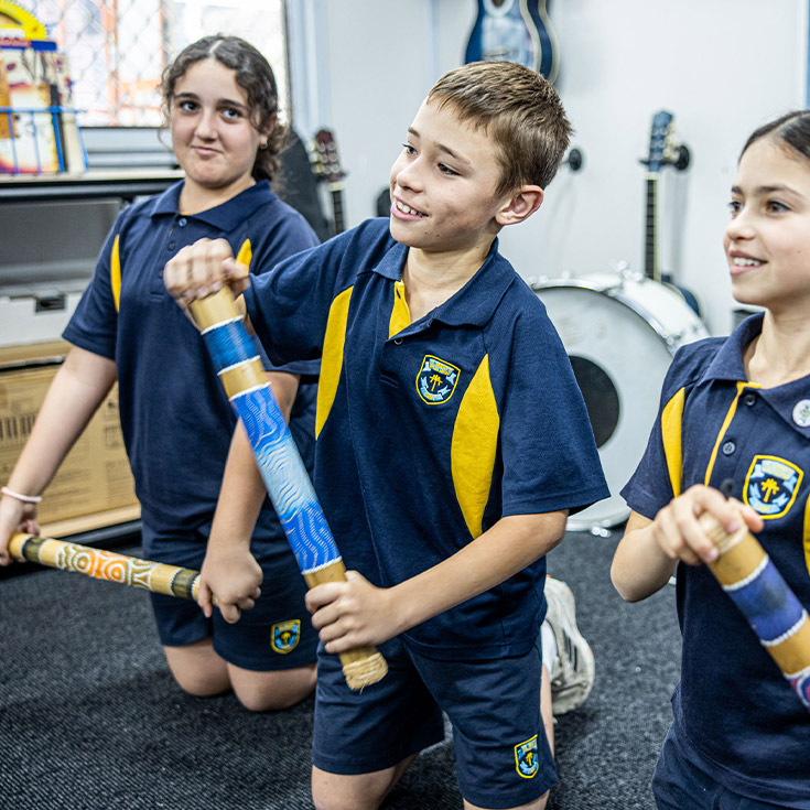 Students playing Indigenous instruments in the classroom at St Mary's Primary School Rydalmere