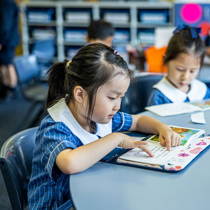 Student reading in the classroom at St Mary's Primary School Rydalmere