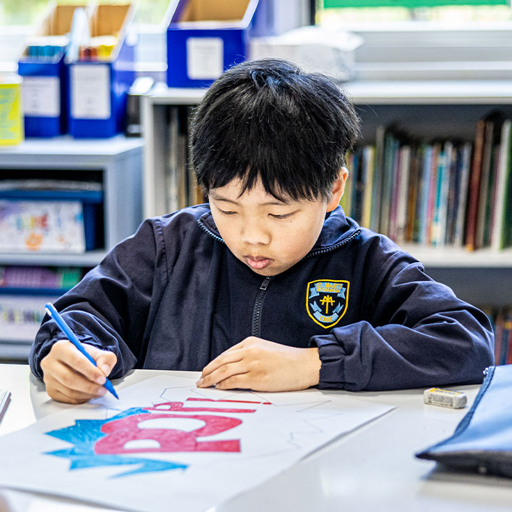 Student drawing in the classroom at St Mary's Primary School Rydalmere