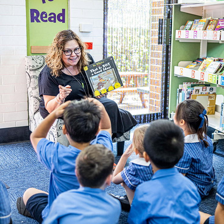 Teacher reading to her students in the library at St Mary's Primary School Rydalmere
